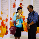 A man and a woman stand next to personal ads at a matchmaking event for middle-aged singles in Shanghai. Divorce rates in China have risen for seven years in a row.